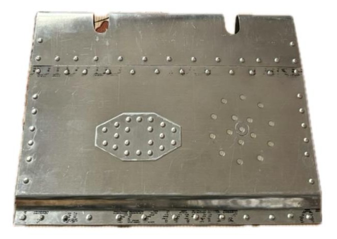 Riveted aileron skin with repair patches