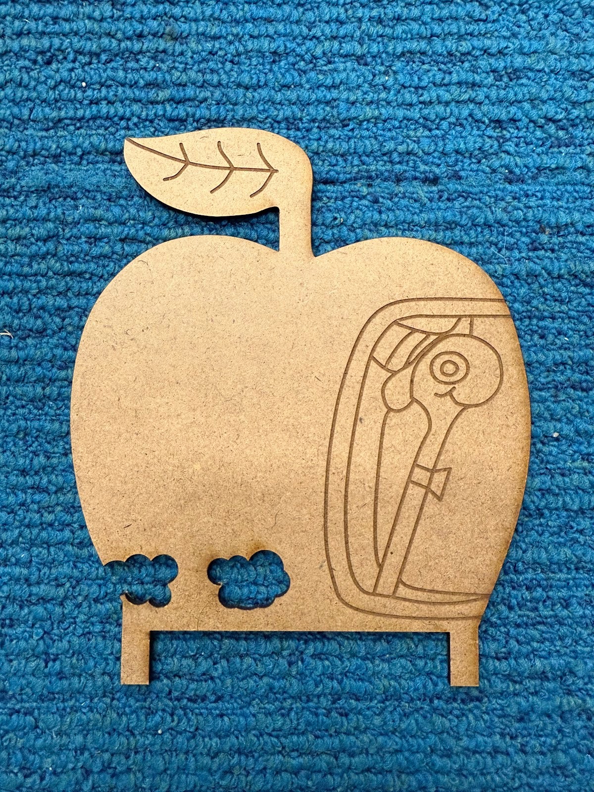 Final Laser cut piece. There are two mirrored side panels but the right hand side is partially important as this is where the powered source and the Arduino usb-c is plugged in. That is, it took “bites” out of the apple in order to allow the necessary electrical while maintaining aesthetics.